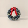 The Christmas wreath is hand-woven with pinecone balls to decorate the storefront wall, creating a festive atmosphere Specification image